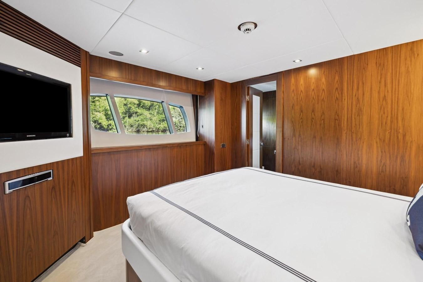 a bedroom with a bed and a television aboard SEAHORSE Yacht for Sale