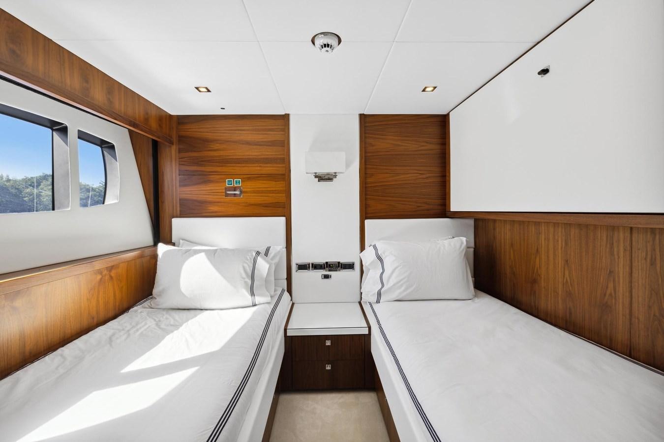 a room with beds and a window aboard SEAHORSE Yacht for Sale