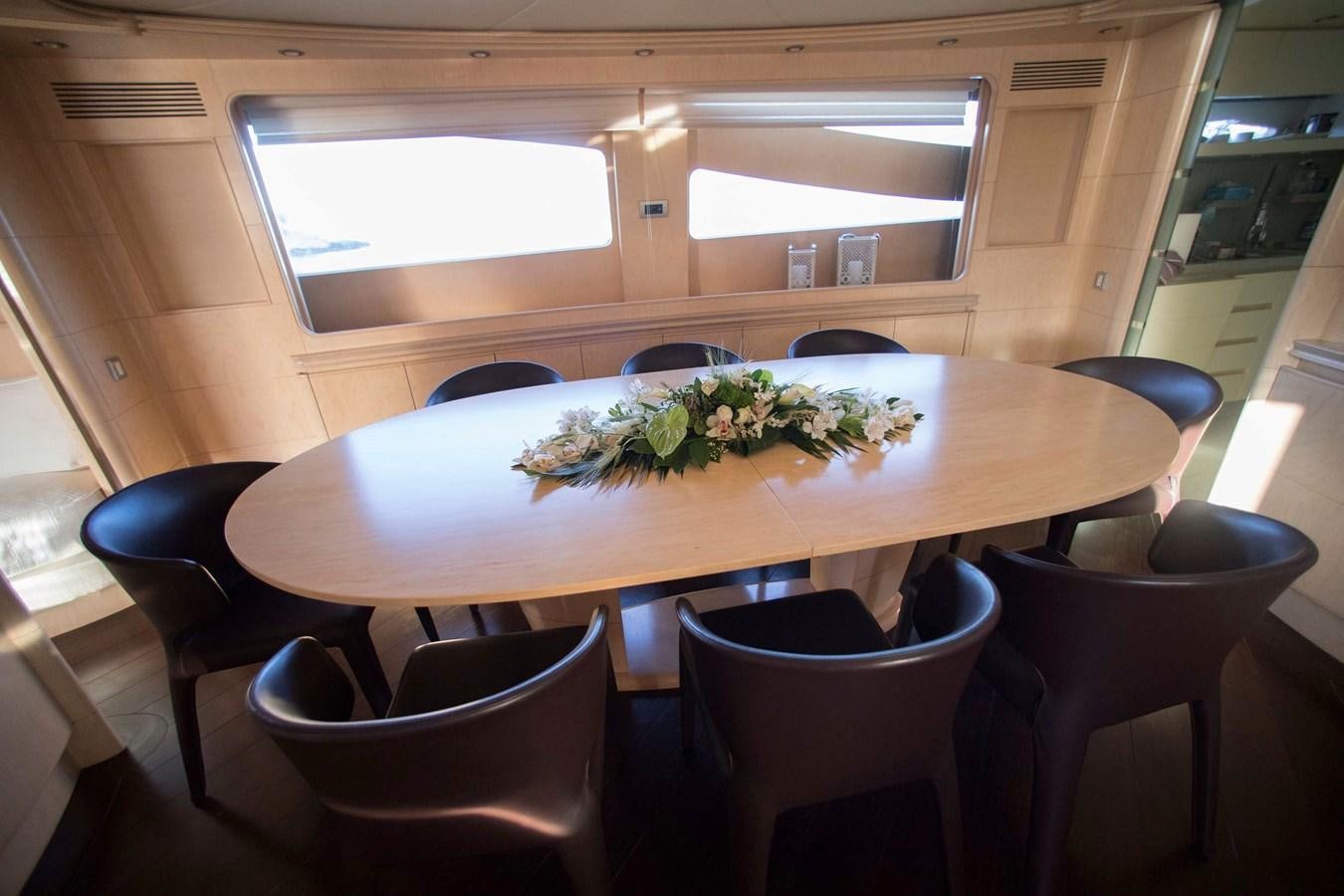 a table with chairs and a plant on it aboard PRINCESS L Yacht for Sale