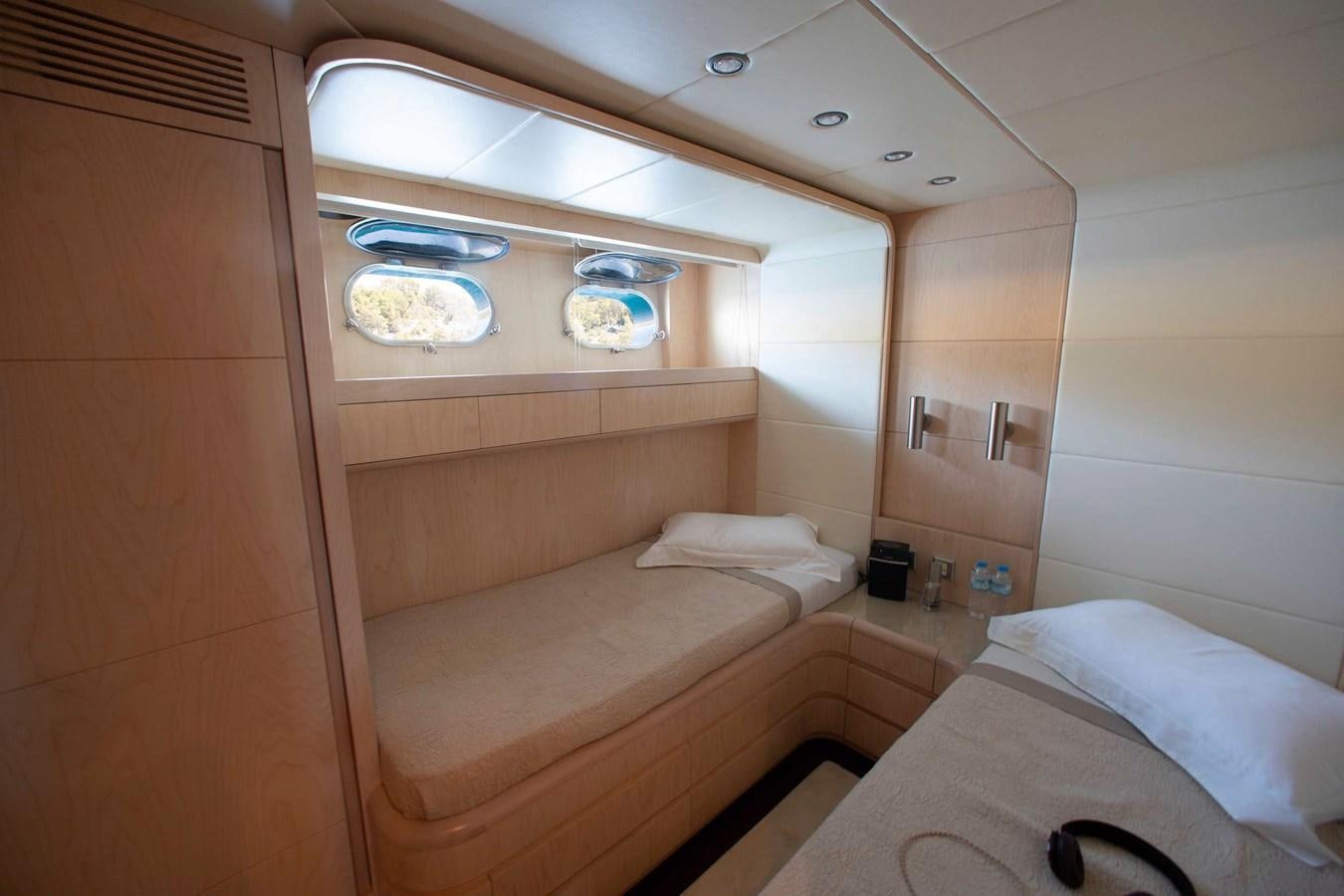a room with a bed and a shelf with food on it aboard PRINCESS L Yacht for Sale