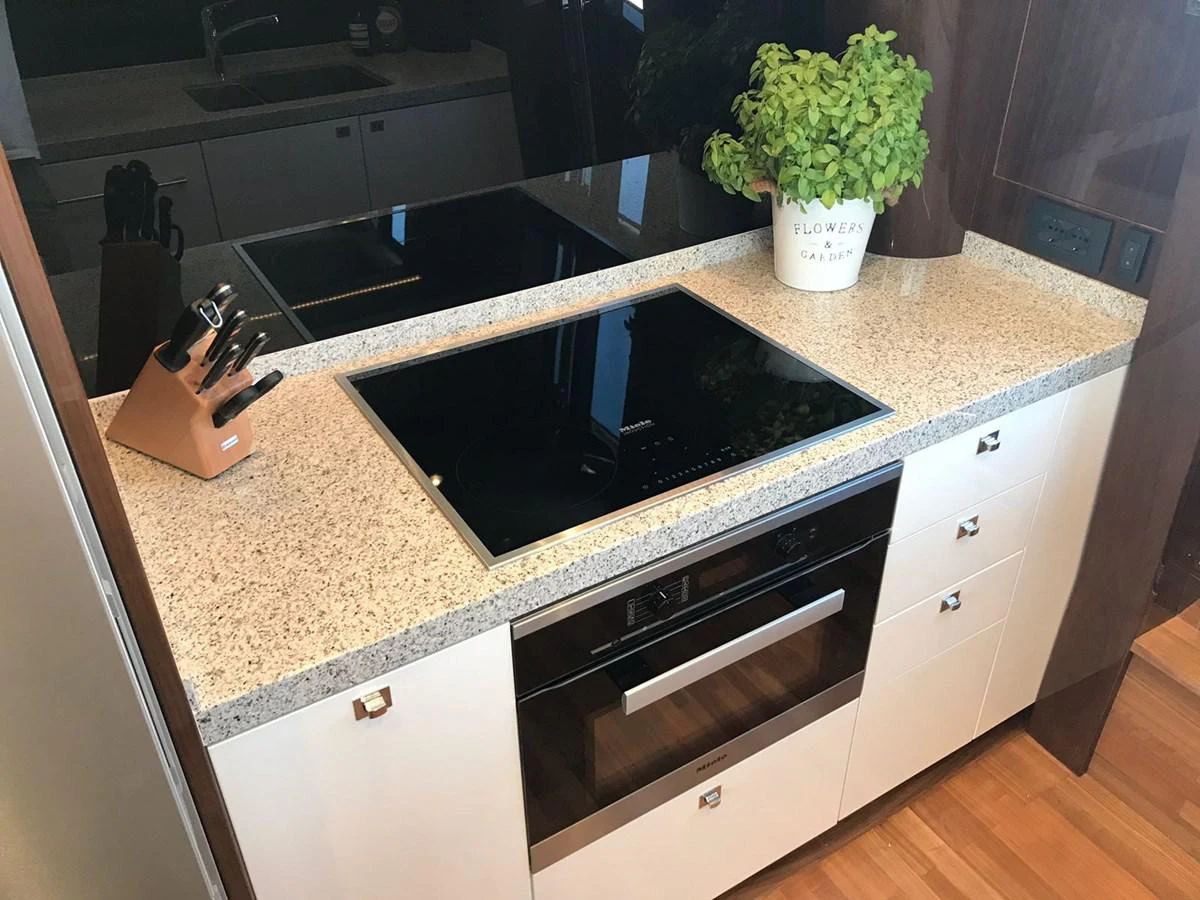 a kitchen with a large black stove aboard ANIKO Yacht for Sale