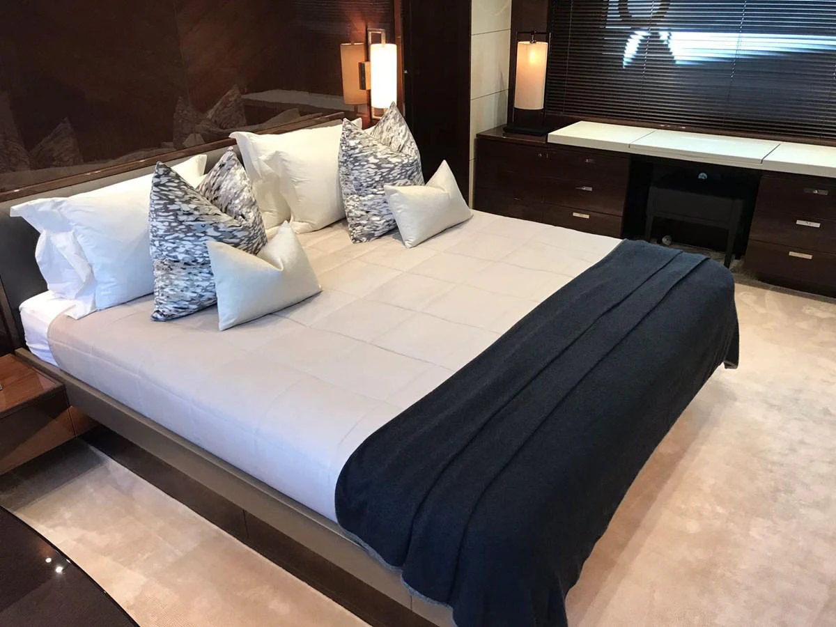 a bed with white sheets aboard ANIKO Yacht for Sale