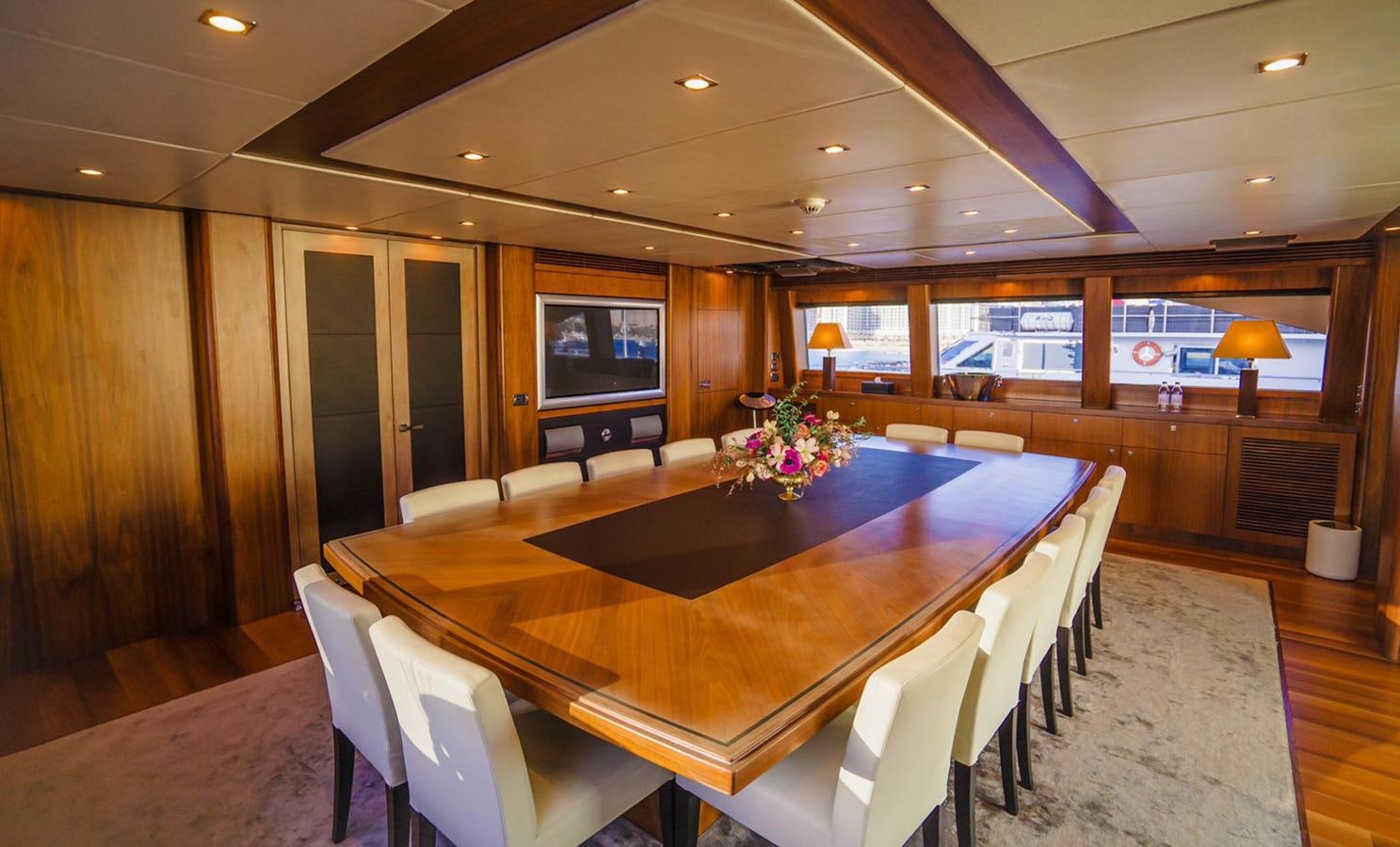a conference room with a table and chairs aboard 2010 SUNSEEKER 40M Yacht for Sale