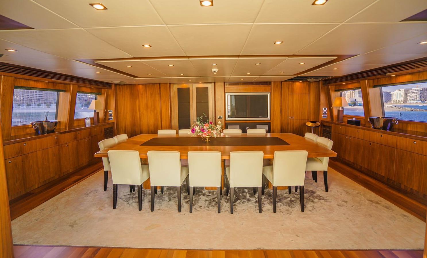 a conference room with a table and chairs aboard 2010 SUNSEEKER 40M Yacht for Sale