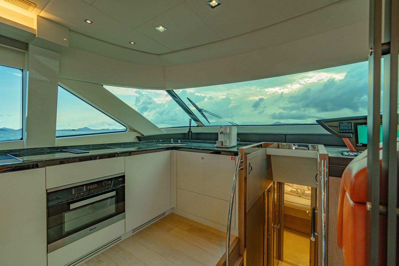 a room with a glass wall and a window with a view of the ocean aboard ILLUZION Yacht for Sale