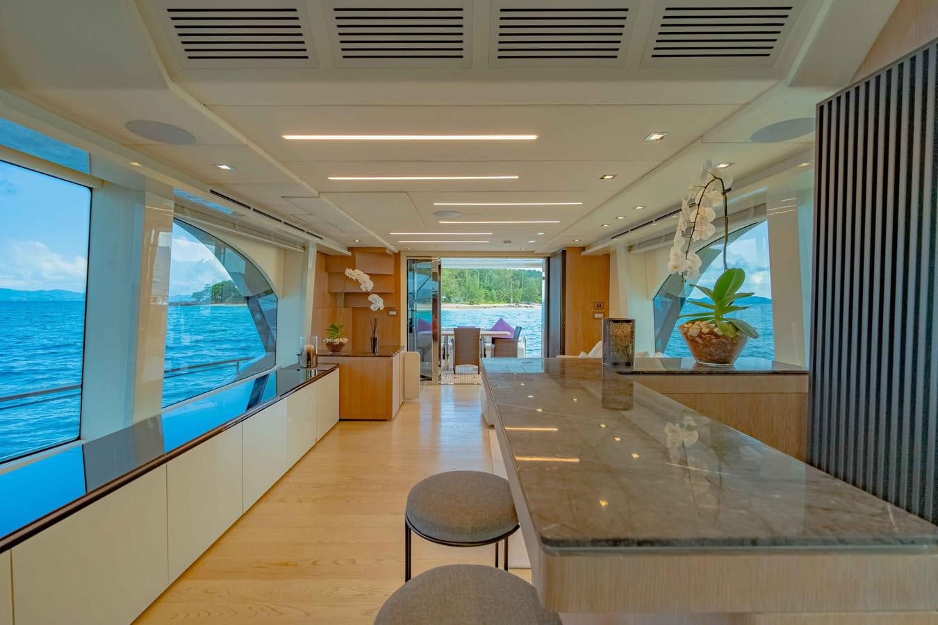 a room with a table and chairs aboard ILLUZION Yacht for Sale