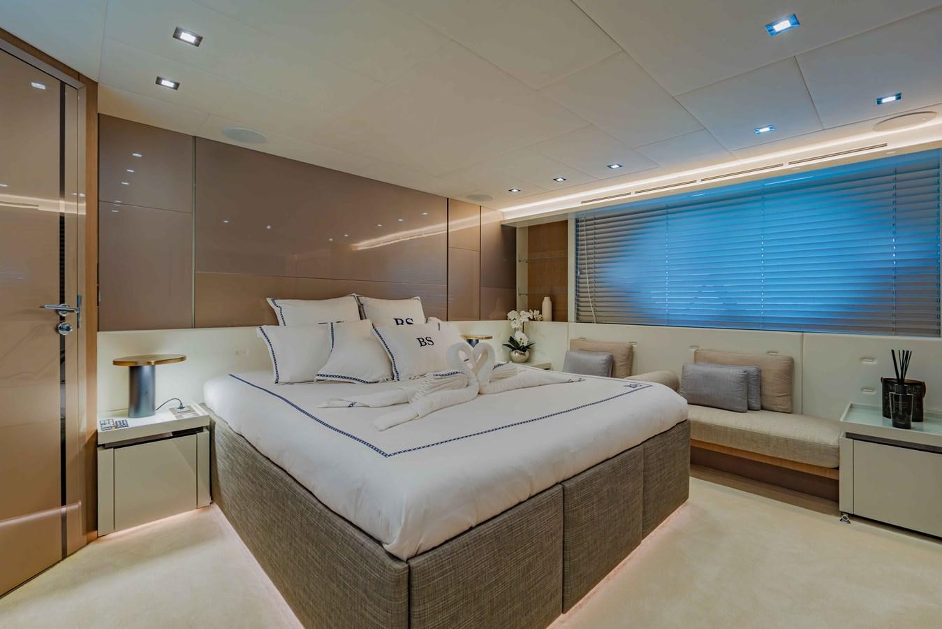 a room with a bed and a window aboard ILLUZION Yacht for Sale