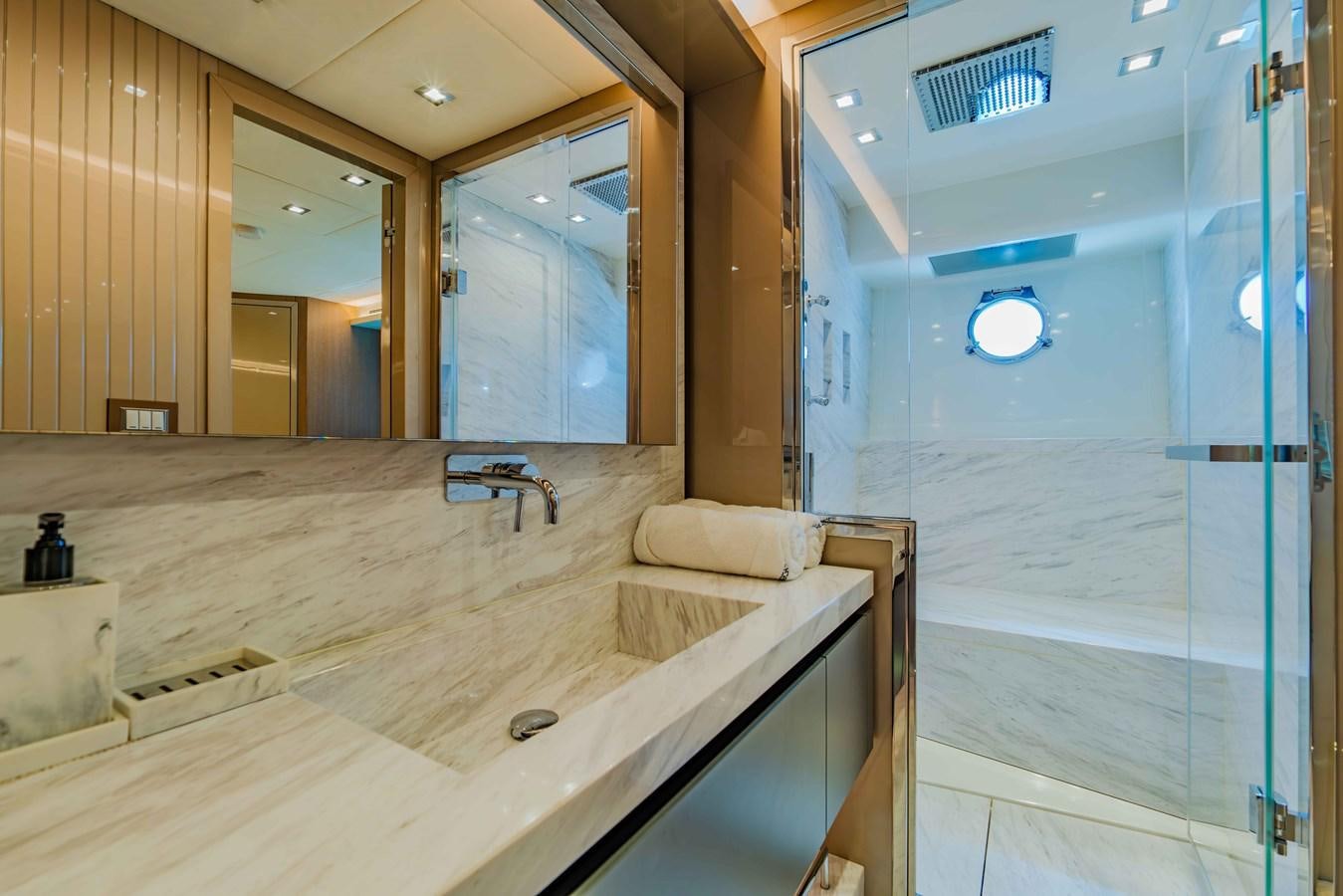 a bathroom with a large mirror aboard ILLUZION Yacht for Sale