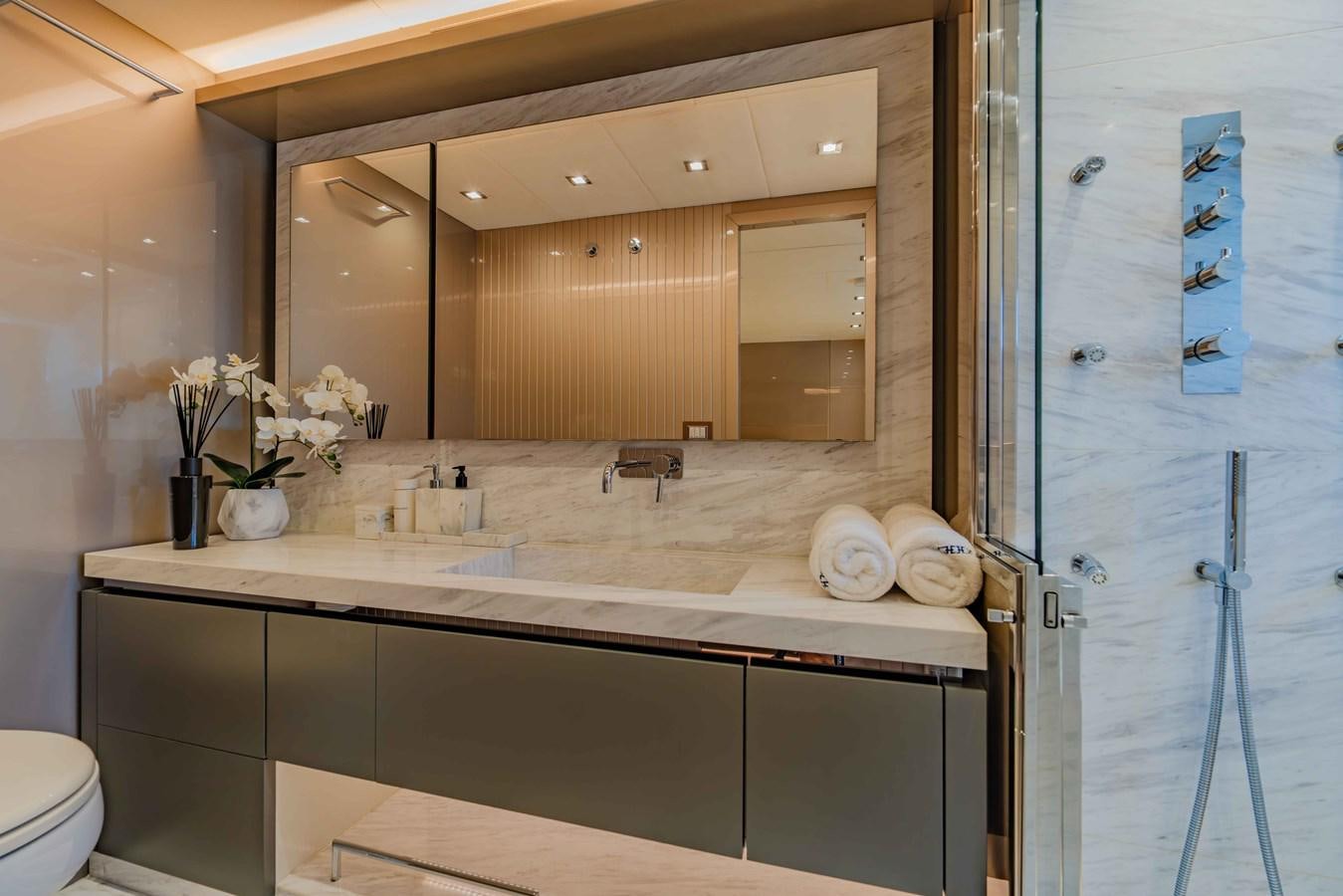 a bathroom with a large mirror aboard ILLUZION Yacht for Sale