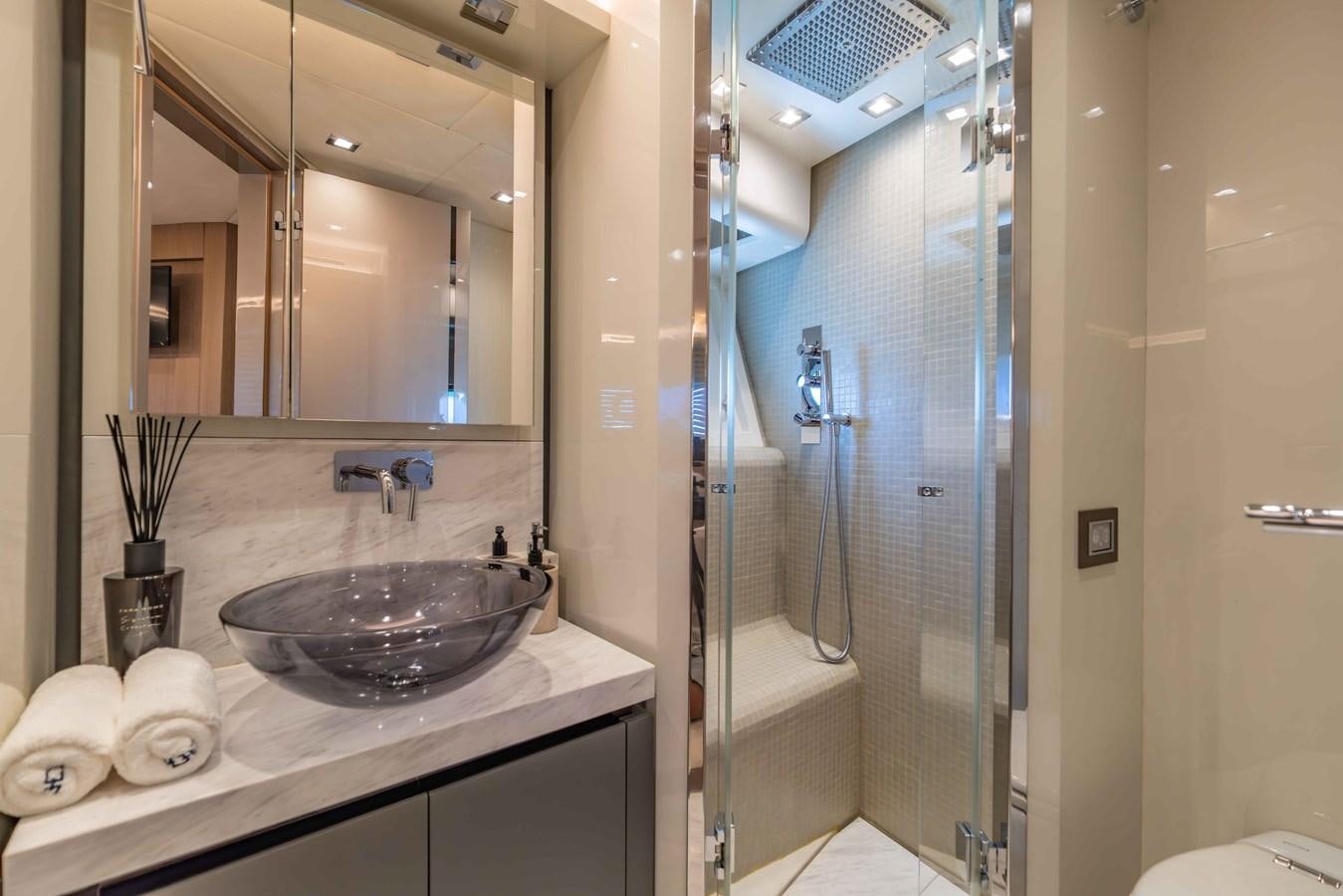 a bathroom with a glass shower aboard ILLUZION Yacht for Sale