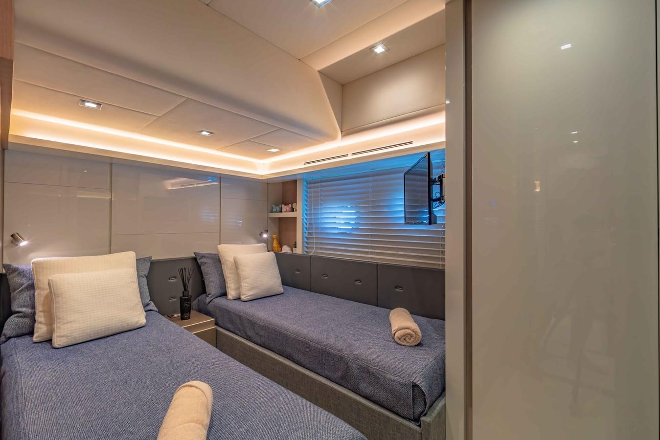 a room with a bed and a tv aboard ILLUZION Yacht for Sale
