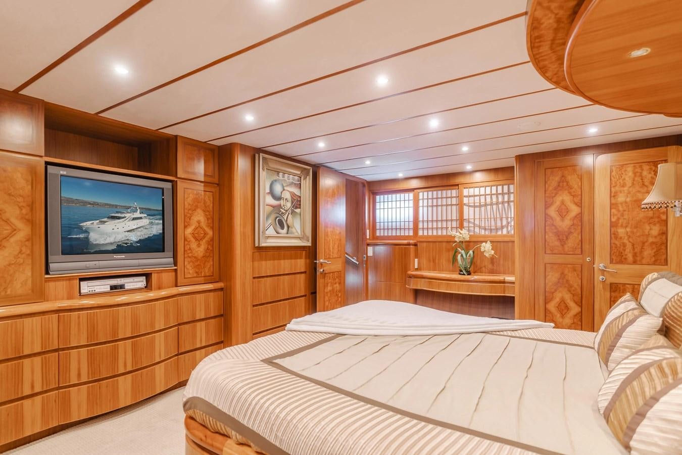 a bedroom with a tv and a bed aboard MONEY CAT Yacht for Sale