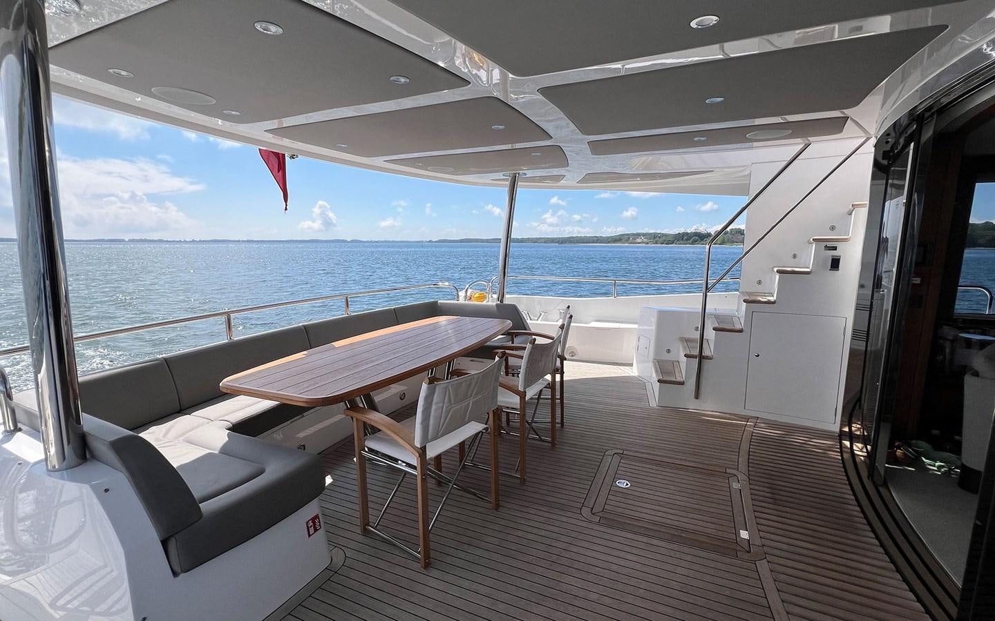 a deck with a table and chairs on it aboard SALIVITI Yacht for Sale