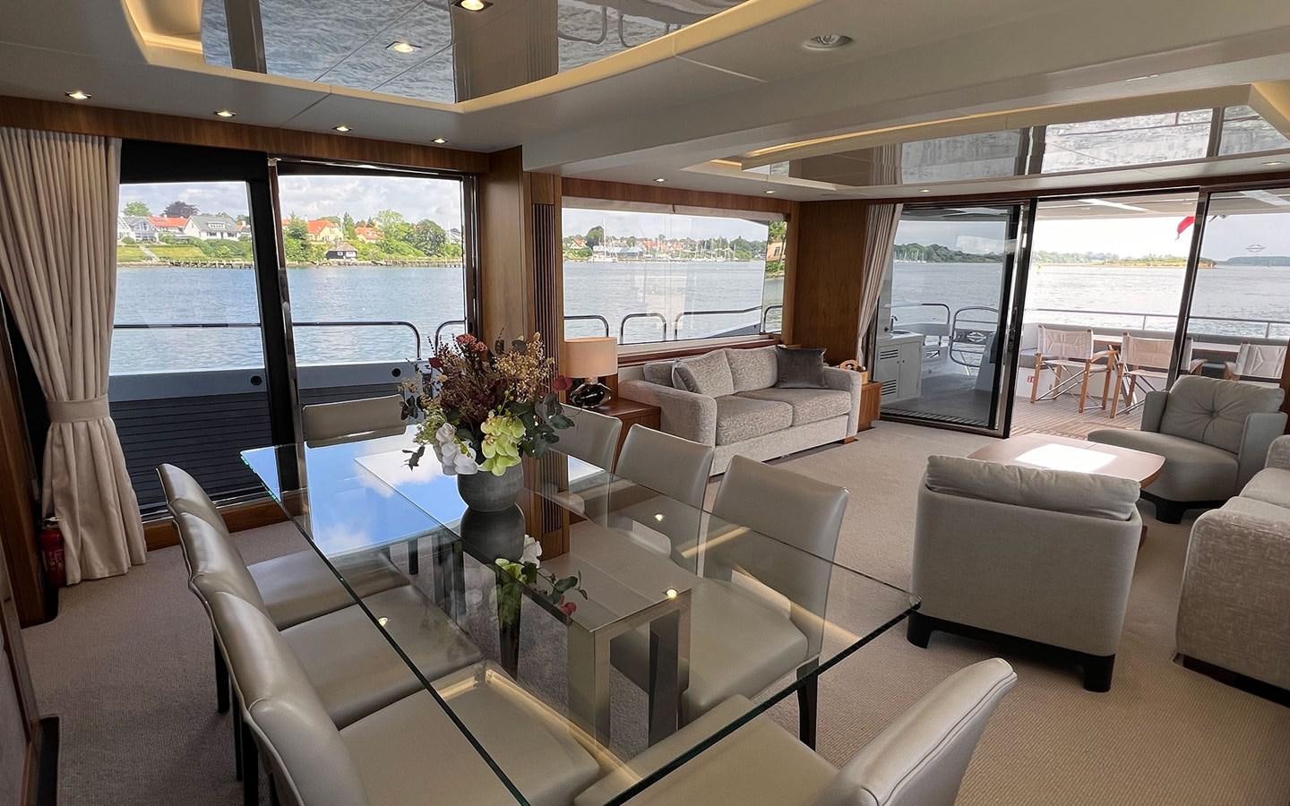 a living room with a large window aboard SALIVITI Yacht for Sale