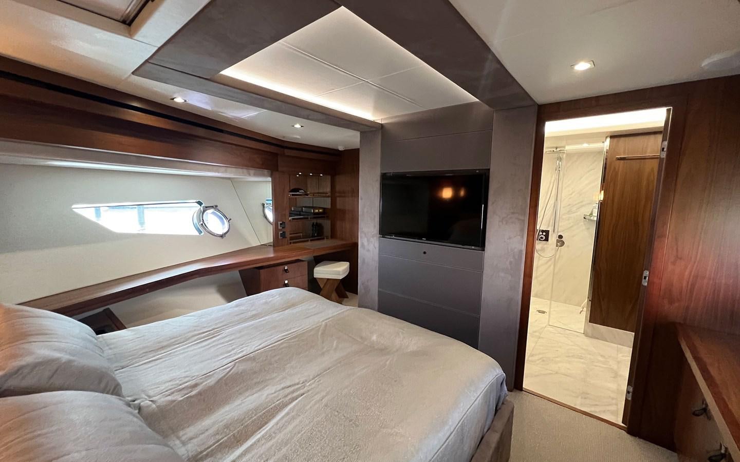 a bedroom with a bed and a television aboard SALIVITI Yacht for Sale