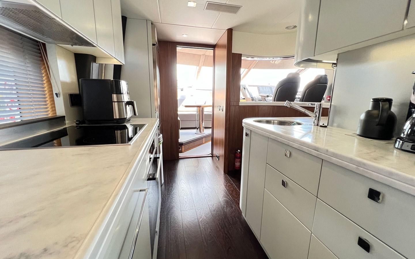 a kitchen with white cabinets aboard SALIVITI Yacht for Sale
