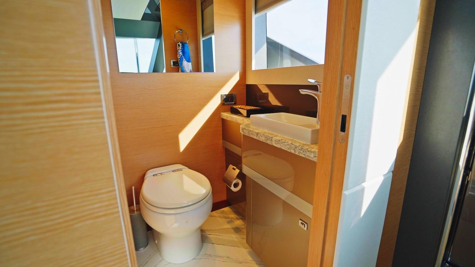 a bathroom with a toilet and a sink aboard PANACEA Yacht for Sale
