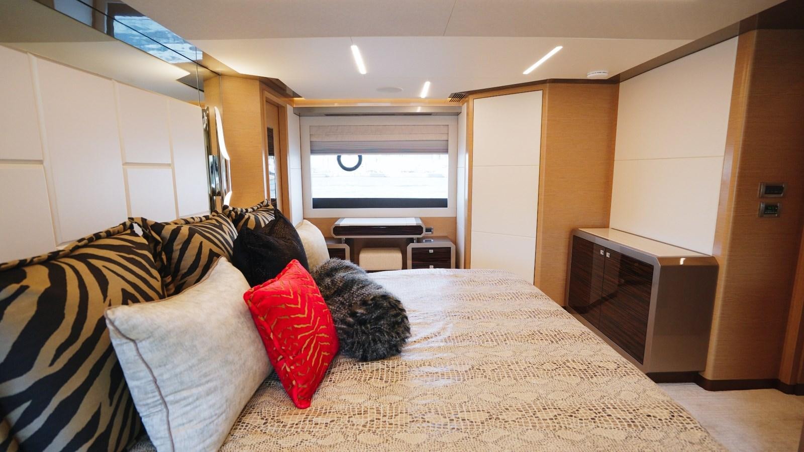 a bedroom with a bed and a desk aboard PANACEA Yacht for Sale