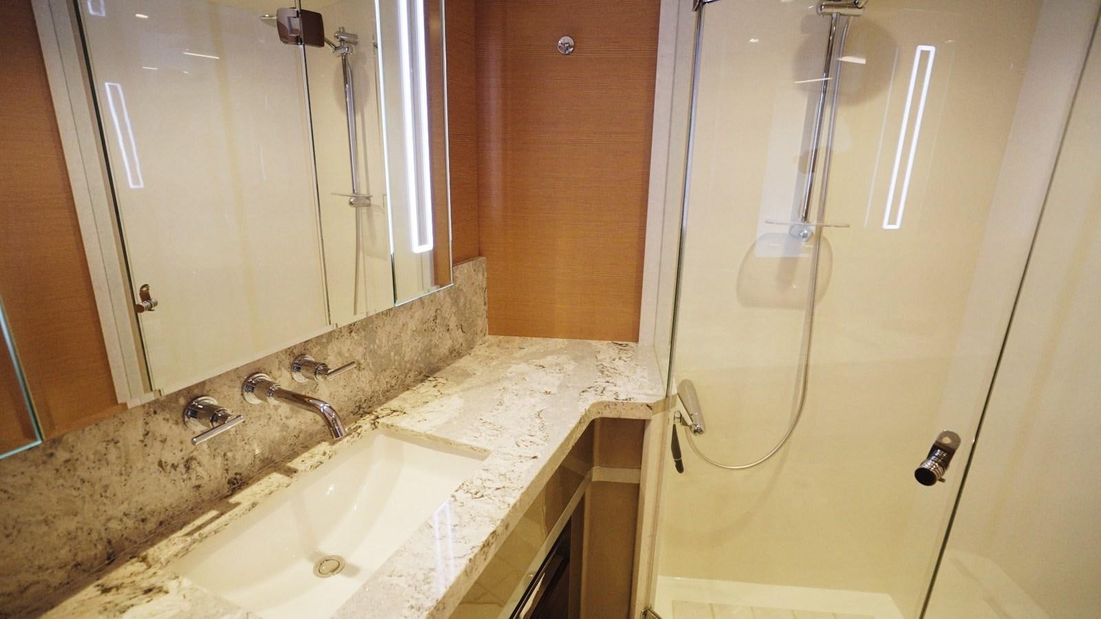 a bathroom with a countertop sink and a shower unit aboard PANACEA Yacht for Sale