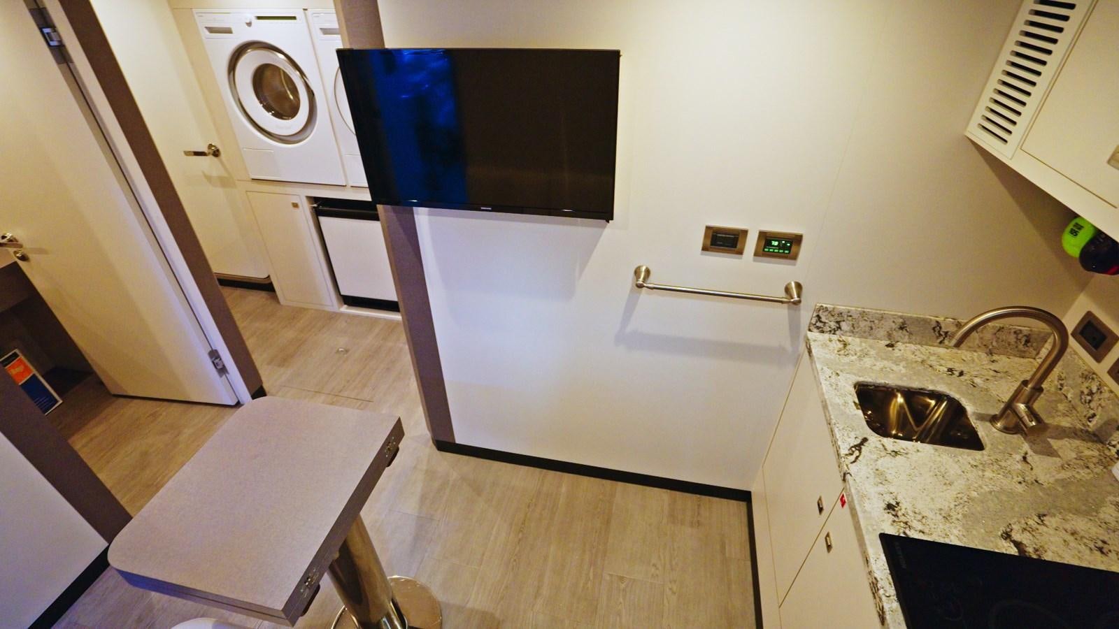 a kitchen with a sink and microwave aboard PANACEA Yacht for Sale