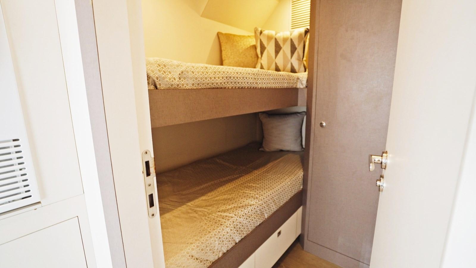 a room with a bed and a chair aboard PANACEA Yacht for Sale