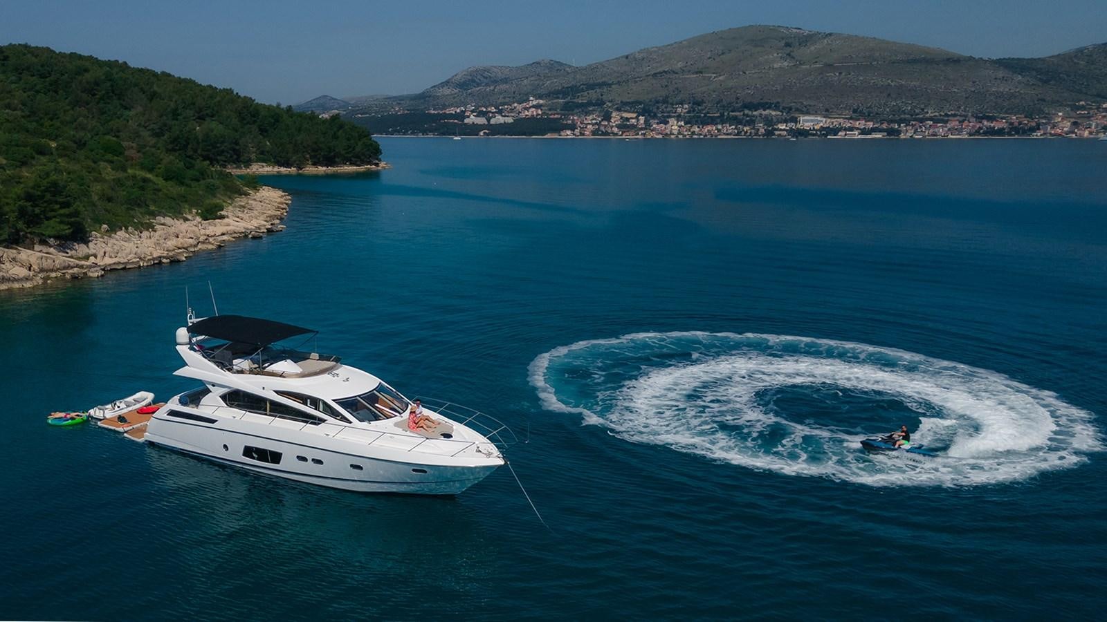 a man and a woman in a boat on the water aboard CARDANO Yacht for Sale