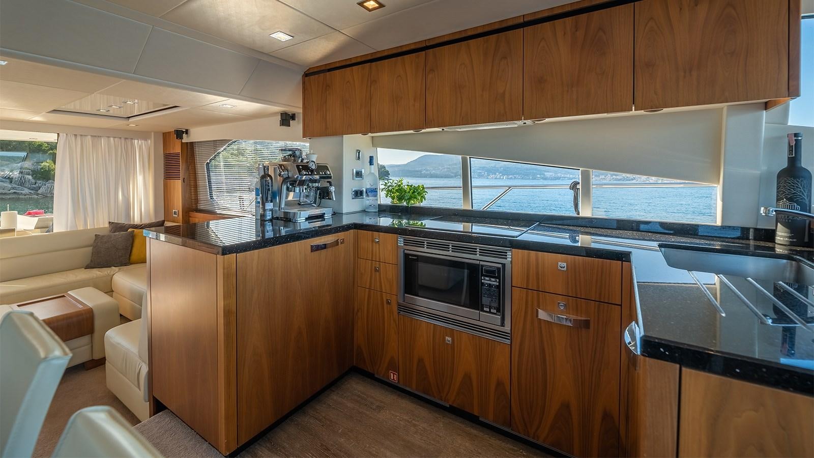 a kitchen with wooden cabinets aboard CARDANO Yacht for Sale