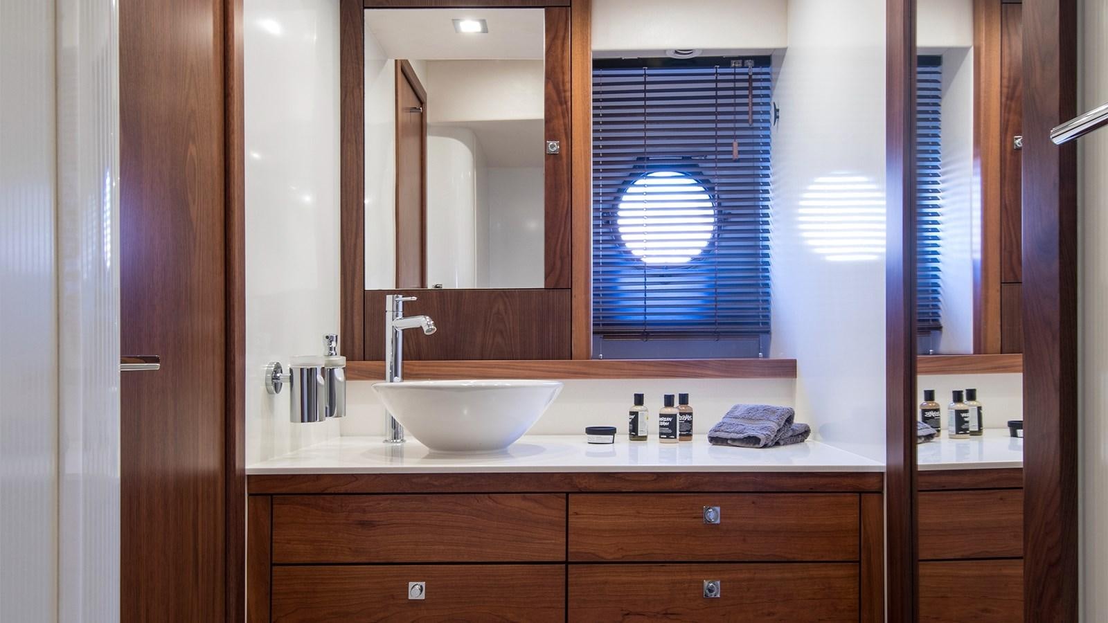 a bathroom with a sink and a mirror aboard CARDANO Yacht for Sale