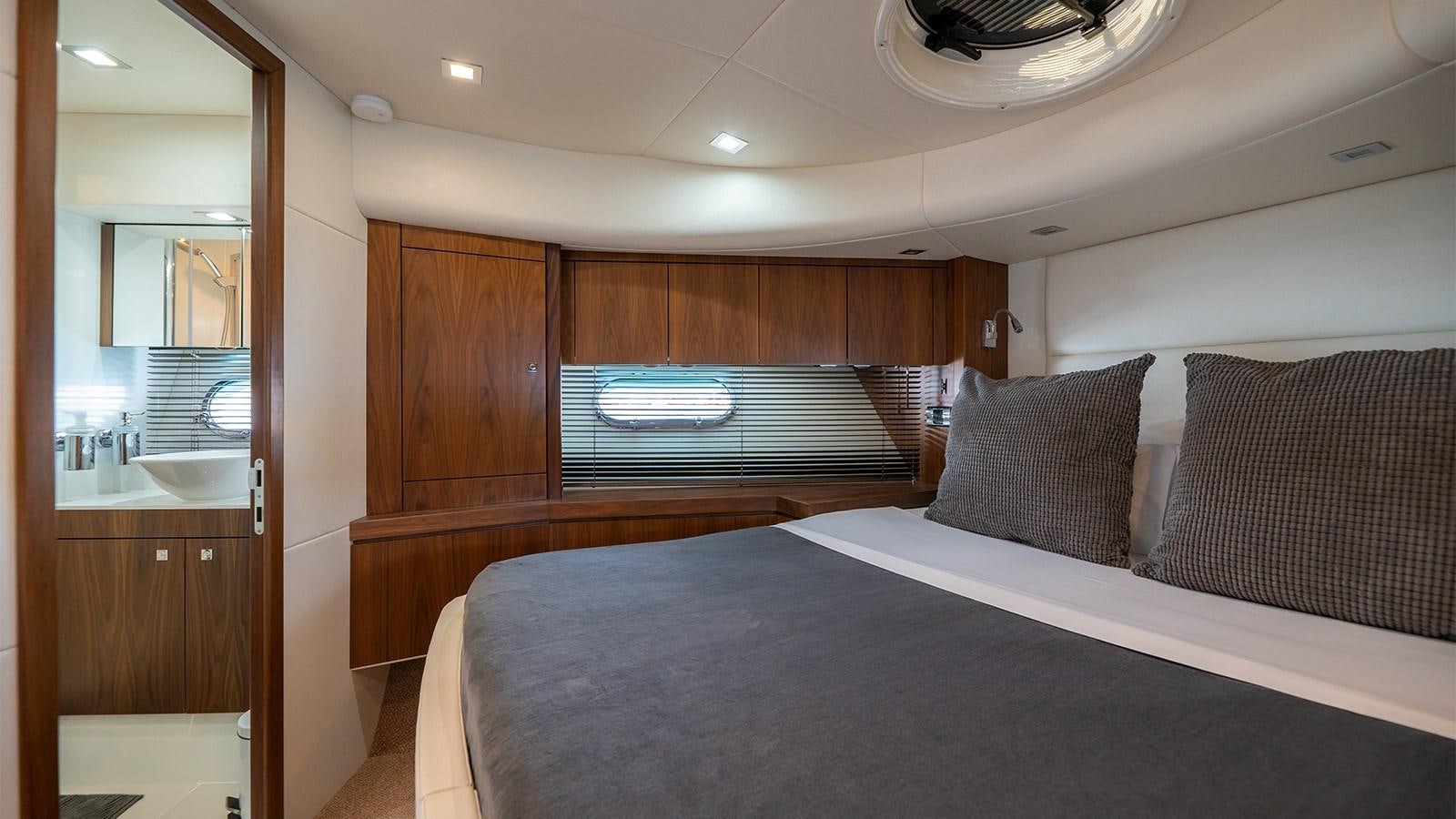 a bedroom with a bed and a mirror aboard CARDANO Yacht for Sale