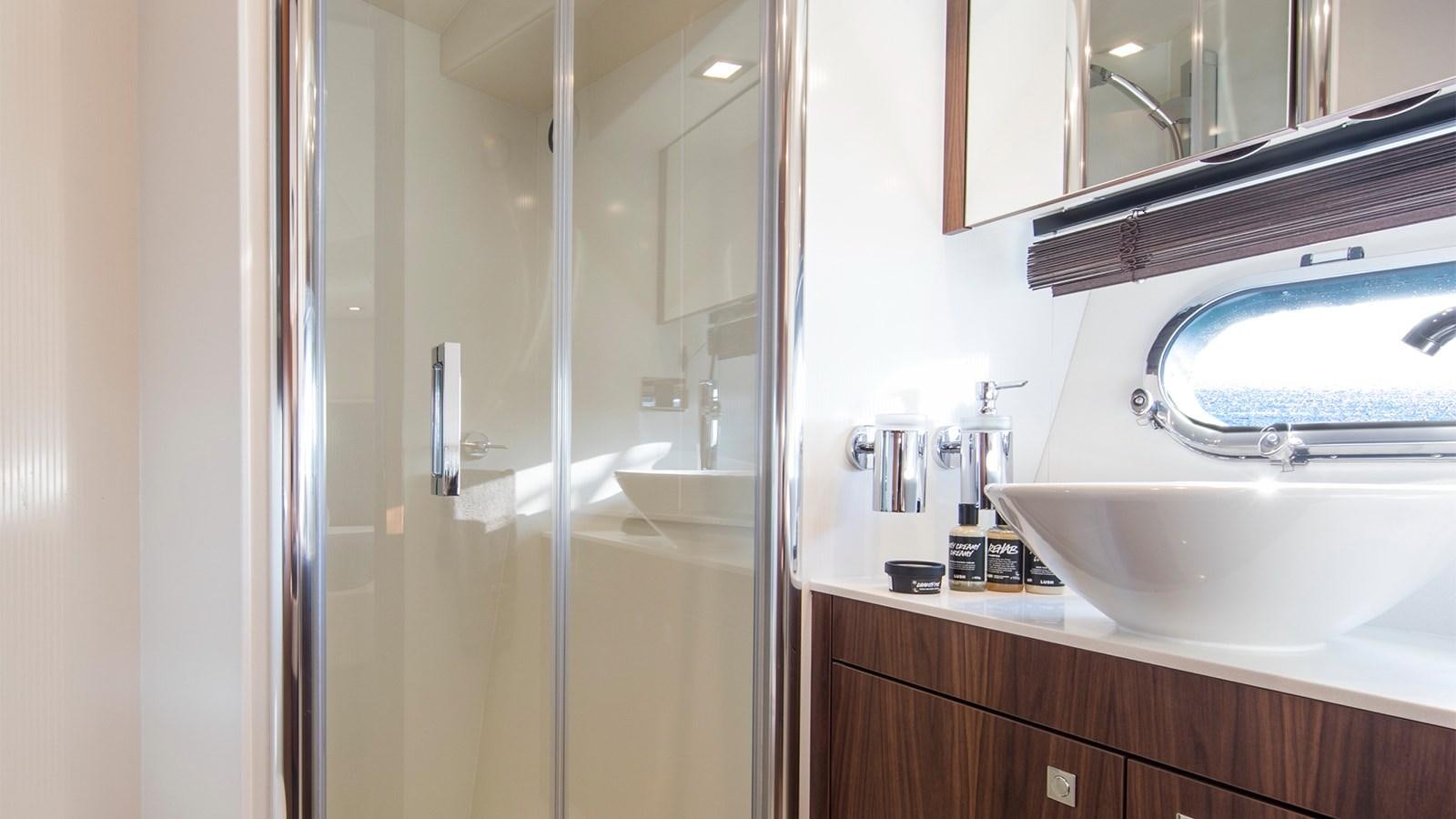 a bathroom with a glass shower aboard CARDANO Yacht for Sale