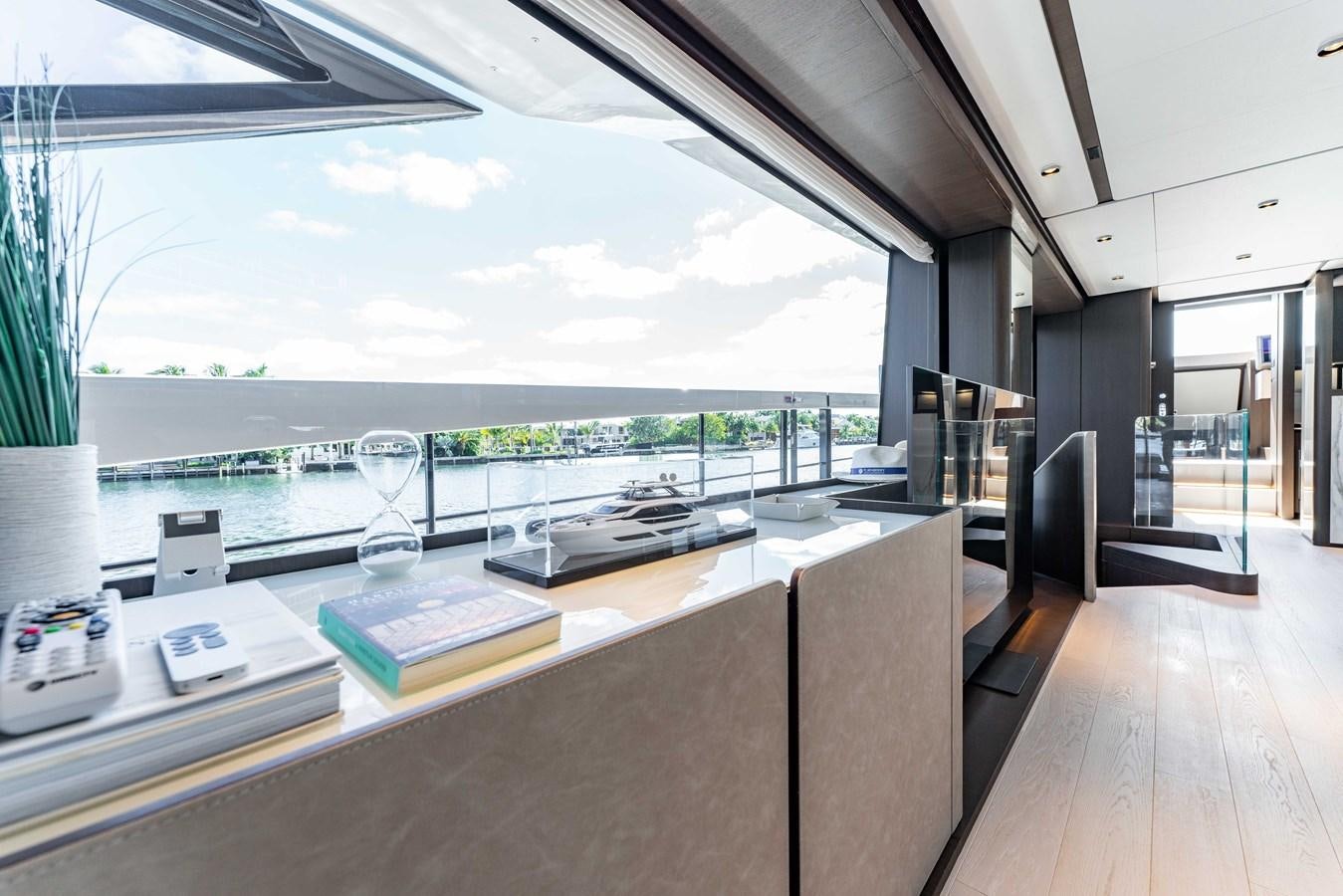 a room with a large window and a table with chairs and a view of the water aboard VITTORIA Yacht for Sale