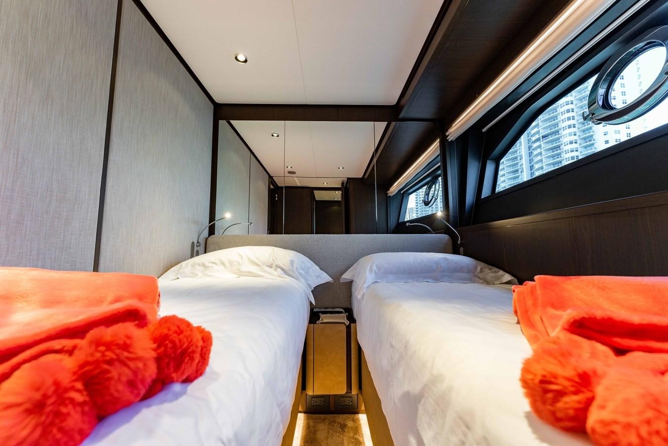 a room with beds and a window aboard VITTORIA Yacht for Sale