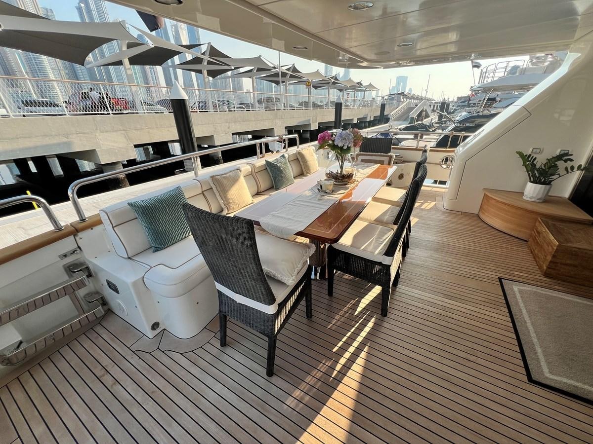 a room with a table chairs and plants aboard 2009 BENETTI 85 LEGEND Yacht for Sale