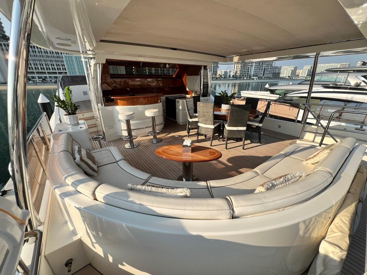 a room with a table chairs and a large window aboard 2009 BENETTI 85 LEGEND Yacht for Sale