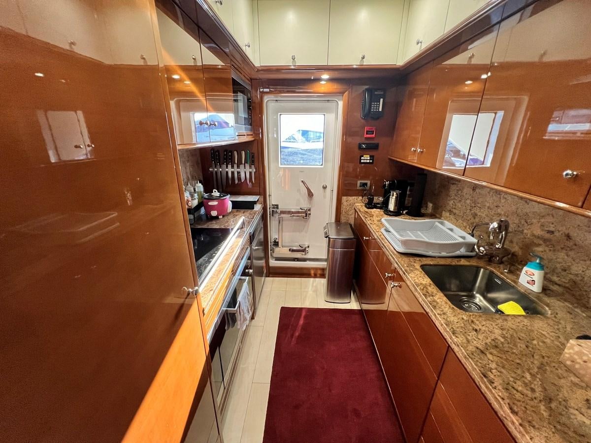 a kitchen with a red rug aboard 2009 BENETTI 85 LEGEND Yacht for Sale