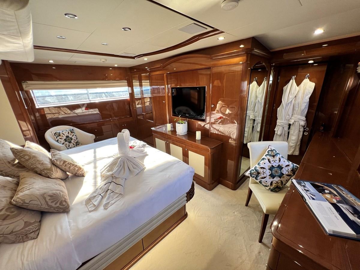 a bedroom with a bed and a television aboard 2009 BENETTI 85 LEGEND Yacht for Sale