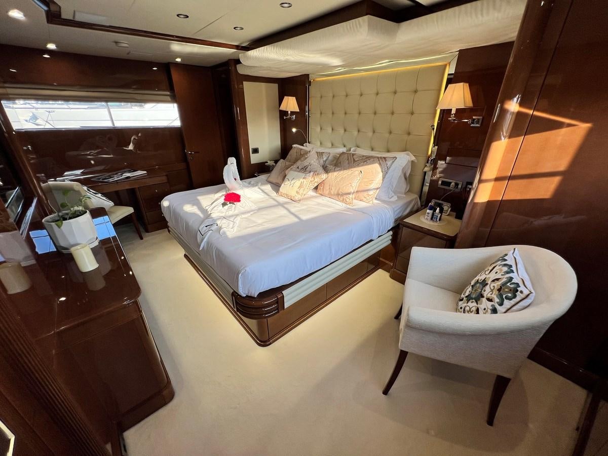 a hotel room with a bed and a chair aboard 2009 BENETTI 85 LEGEND Yacht for Sale