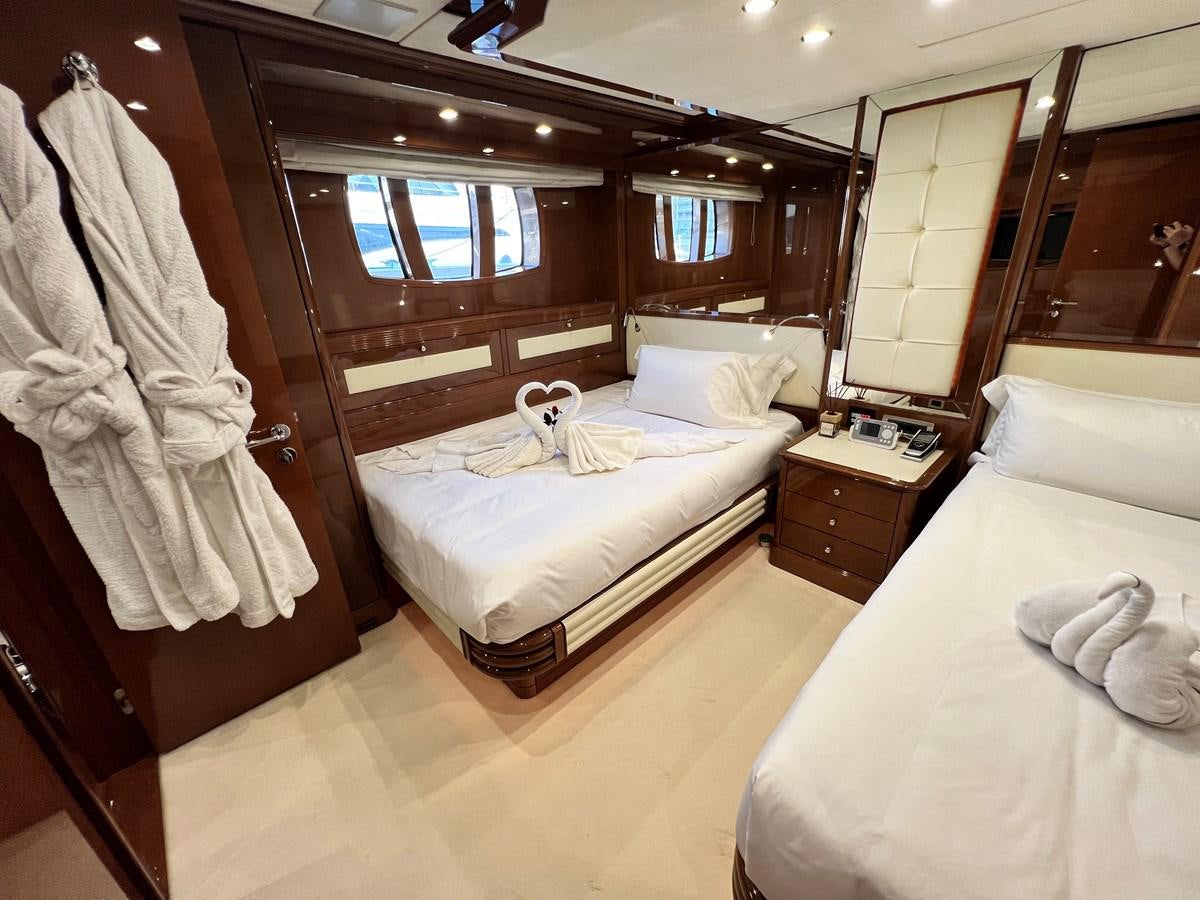 a room with a bed and a mirror aboard 2009 BENETTI 85 LEGEND Yacht for Sale