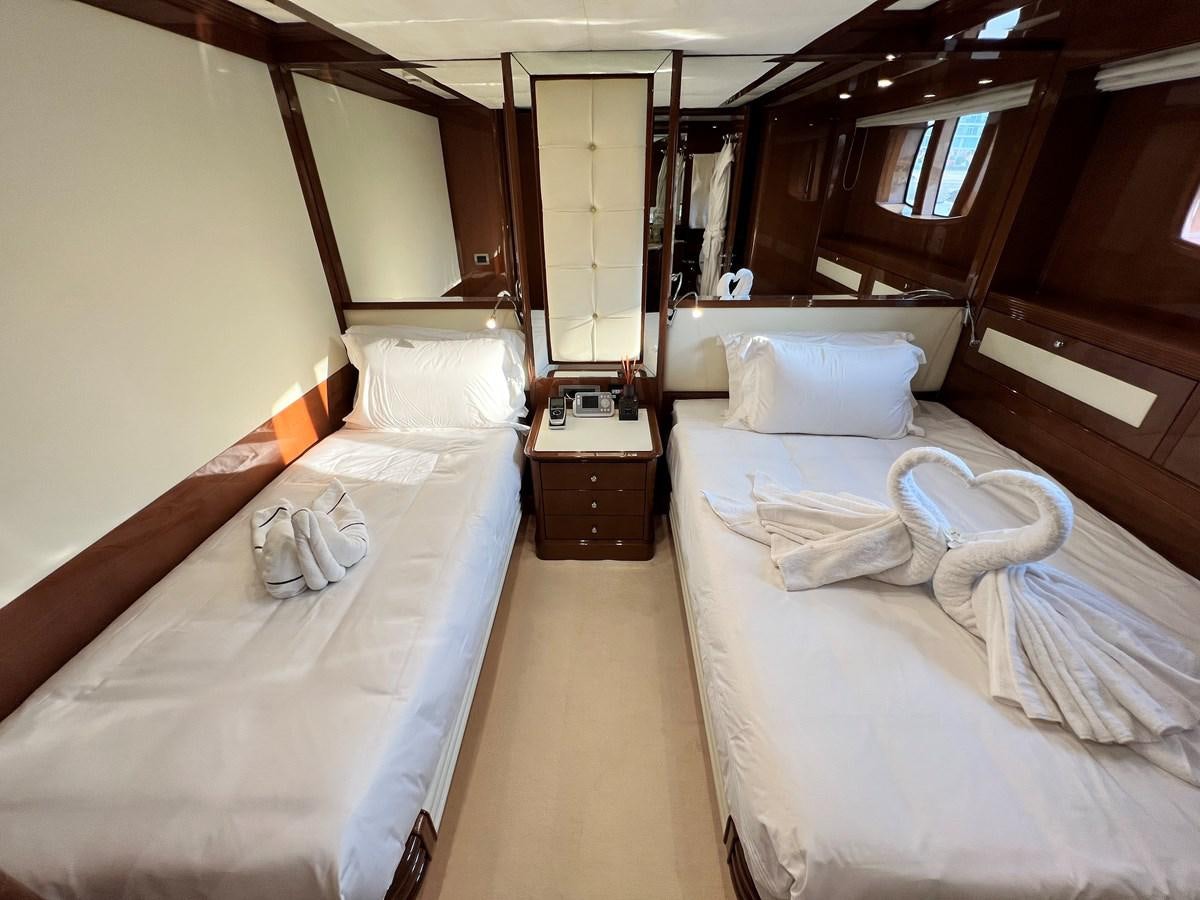 a room with two beds aboard 2009 BENETTI 85 LEGEND Yacht for Sale
