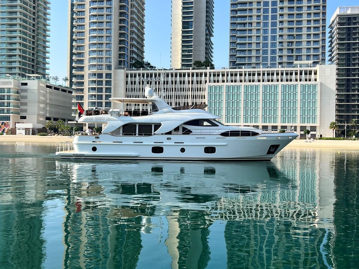 a white boat in a body of water with buildings in the background aboard 2009 BENETTI 85 LEGEND Yacht for Sale