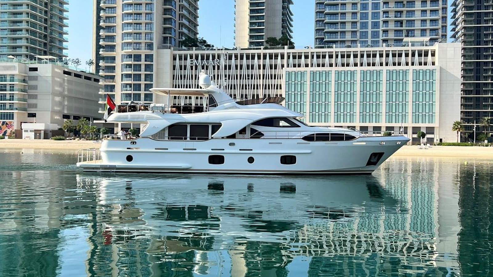 a white boat in a body of water with buildings in the background aboard 2009 BENETTI 85 LEGEND Yacht for Sale