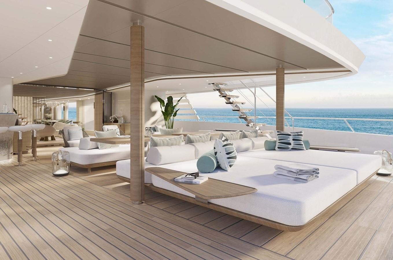 a large white lounge chair next to a large white bed on a wood floor next to a large aboard PROJECT SECRET Yacht for Sale