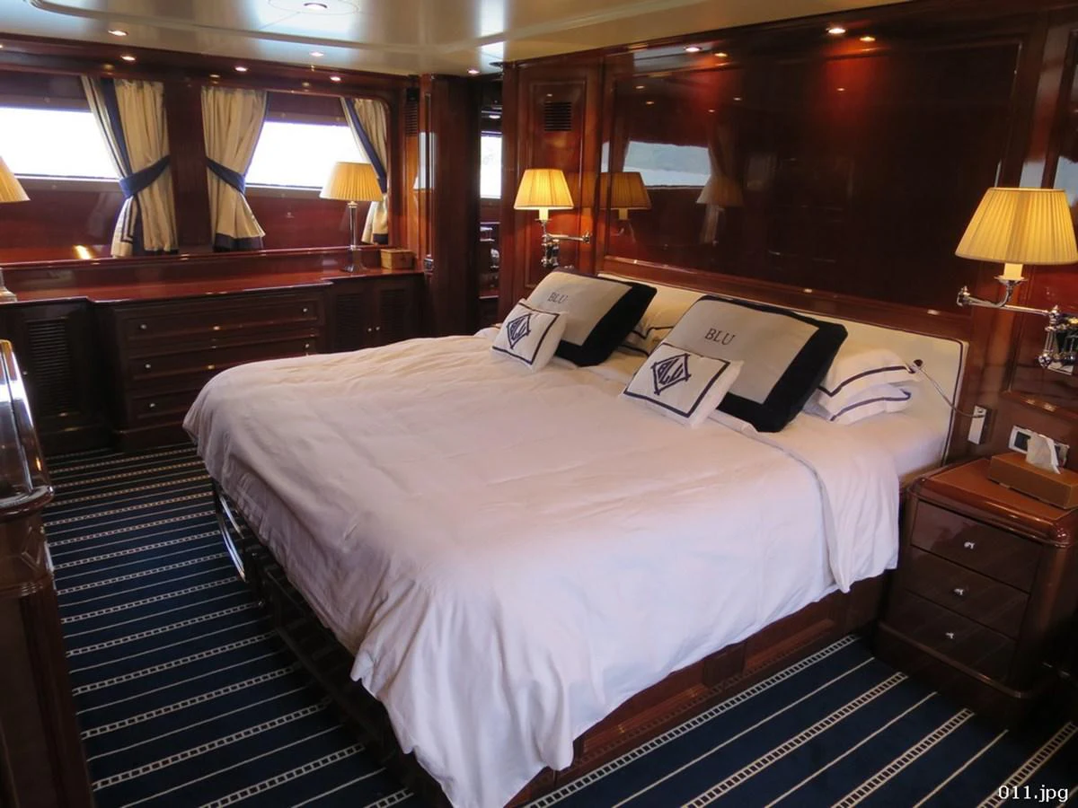 a hotel room with a bed and a desk aboard BLU Yacht for Sale