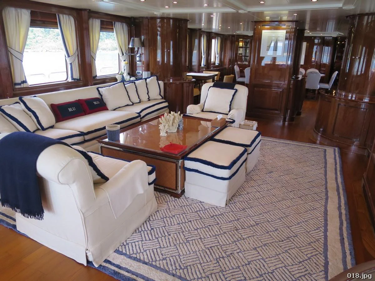 a living room with a couch and a coffee table aboard BLU Yacht for Sale