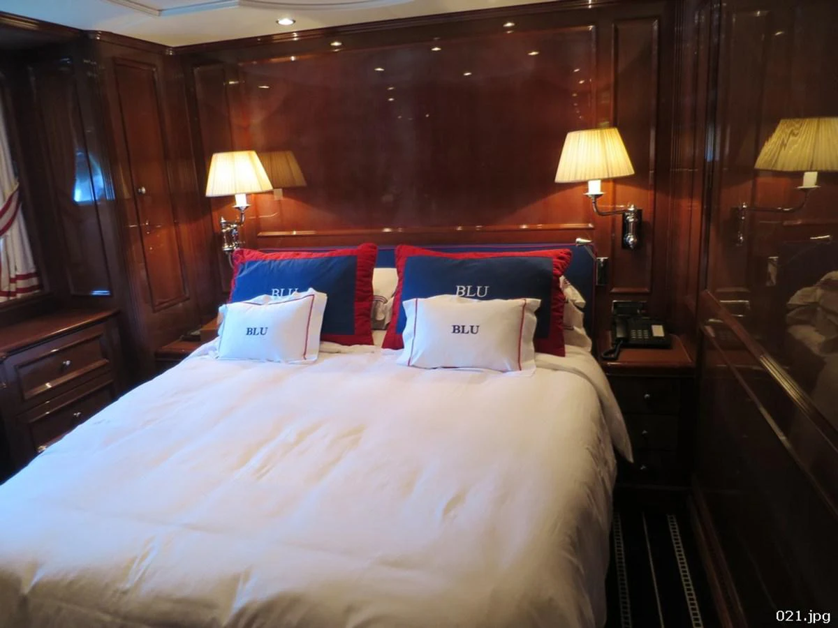 a bed with pillows on it aboard BLU Yacht for Sale