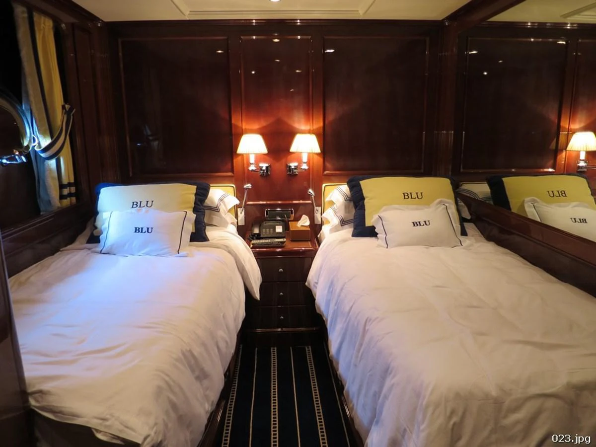 a couple of beds in a hotel room aboard BLU Yacht for Sale