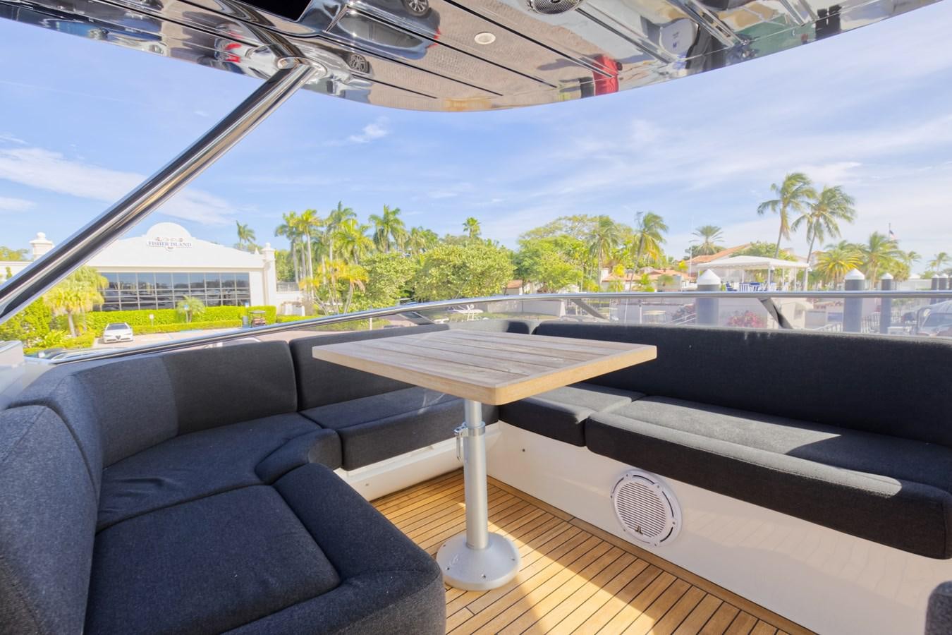 a table and a couch on a deck aboard XSK06864H718 Yacht for Sale