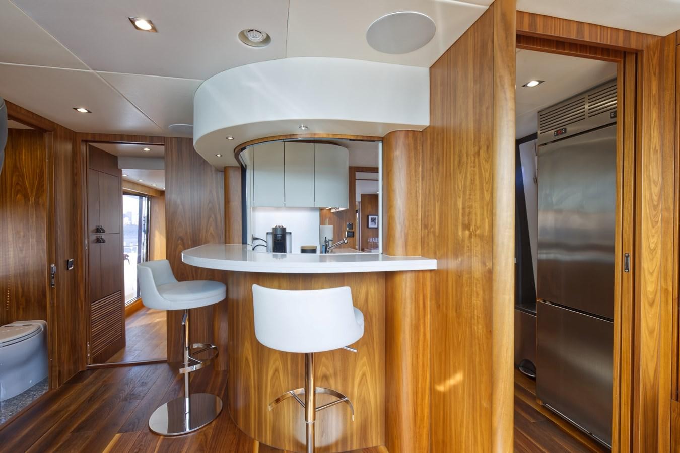 a kitchen with a sink and stools aboard XSK06864H718 Yacht for Sale