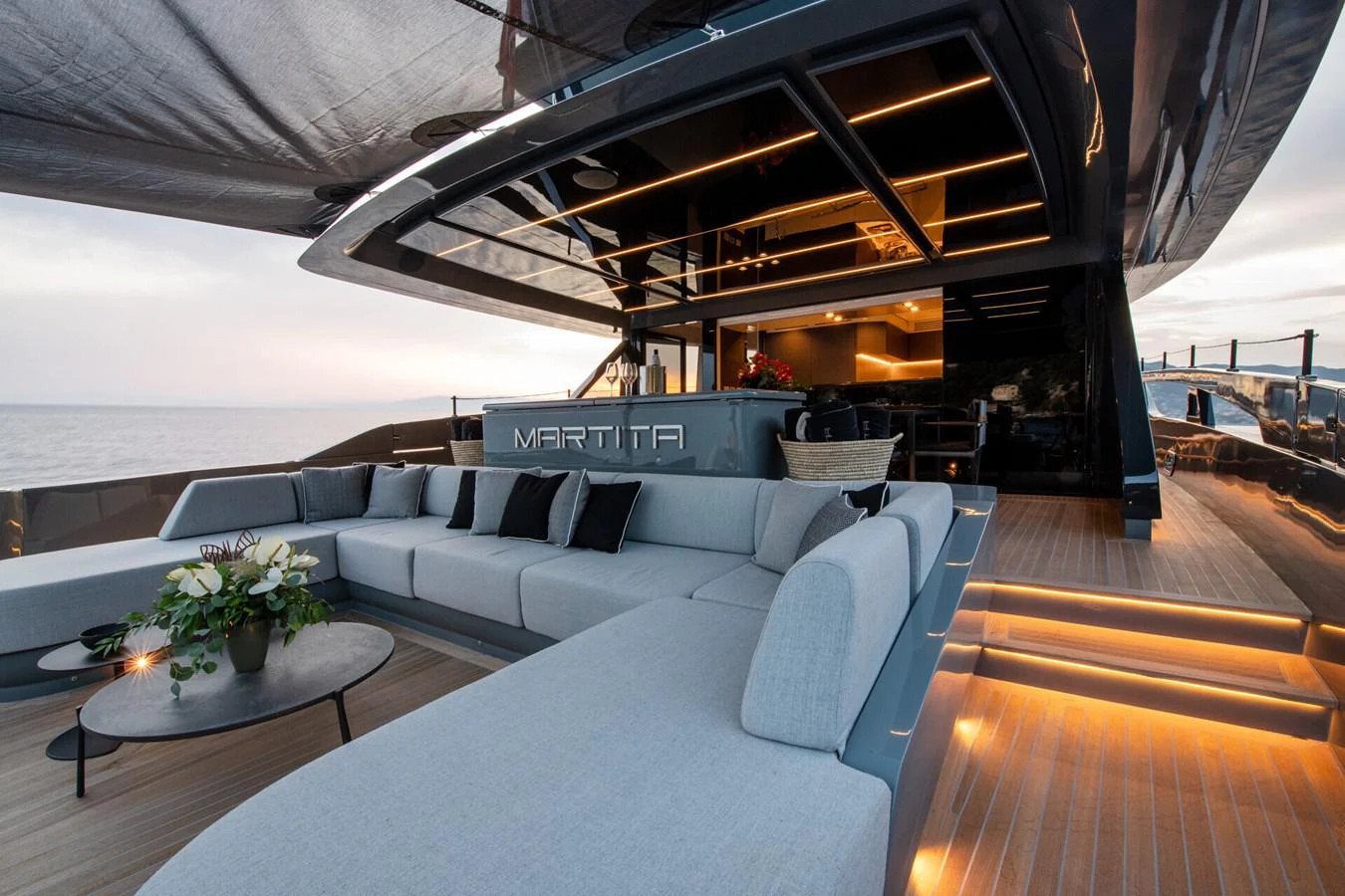 a large living room with a large white couch and a table aboard MARTITA Yacht for Sale