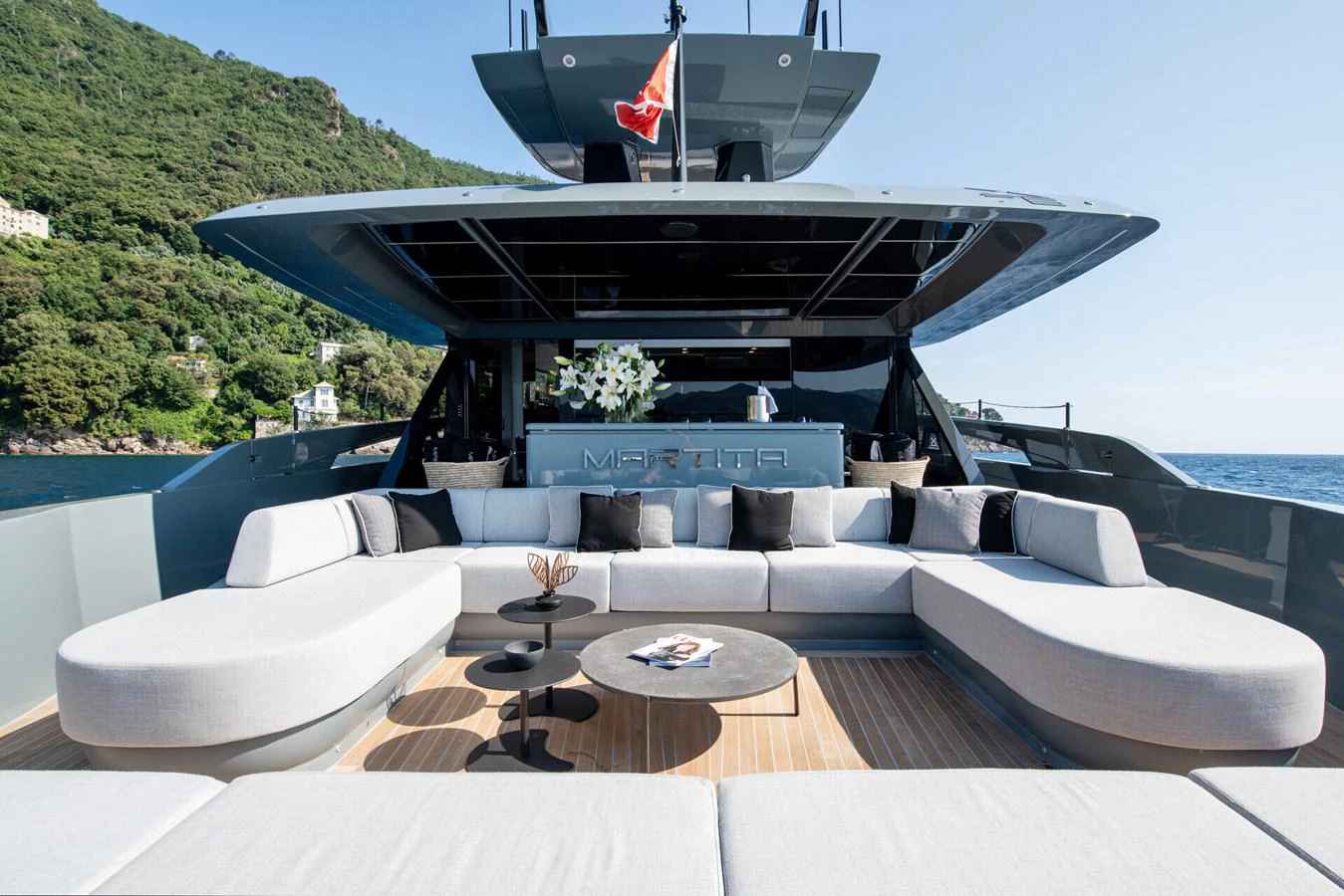 a large white lounge chair on a boat on a large body of water aboard MARTITA Yacht for Sale